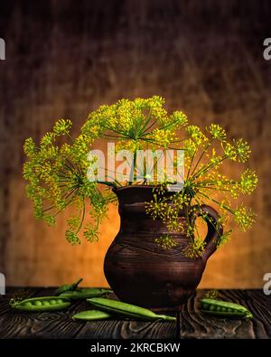 Clay jug on a dark background with dill branches and peas Stock Photo