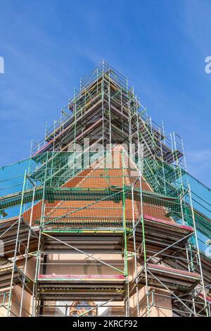 Scaffolding around a church tower for renovation in Bavaria Stock Photo