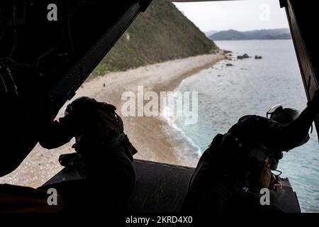 U.S. Marines with Marine Medium Tiltrotor Squadron (VMM) 265 scan the ground prior to landing during exercise Keen Sword 23 at Tutsara Island, Kumamoto, Japan, Nov. 14, 2022.  Keen Sword exercises the combined capabilities and lethality developed between the 1st Marine Aircraft Wing, III Marine Expeditionary Force, and the Japan Self Defense Force (JSDF). This bilateral field-training exercise between the U.S. military and JSDF strengthens interoperability and combat readiness of the U.S.-Japan Alliance. Stock Photo