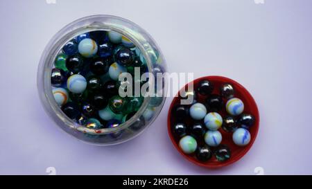 lots of colorful children's toy marbles in plastic bottles Stock Photo