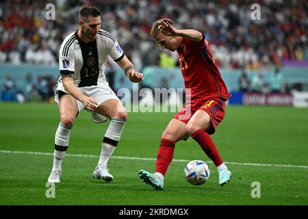 Al Khor, Qatar. 27th Nov, 2022. Soccer: World Cup, Spain - Germany, preliminary round, Group E, Matchday 2, al-Bayt Stadium, Germany's Niklas Süle (l) and Spain's Dani Olmo fight for the ball. Credit: Federico Gambarini/dpa/Alamy Live News Stock Photo