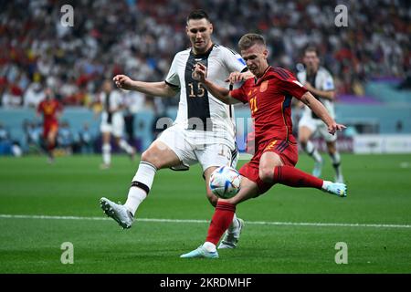 Al Khor, Qatar. 27th Nov, 2022. Soccer: World Cup, Spain - Germany, preliminary round, Group E, Matchday 2, al-Bayt Stadium, Germany's Niklas Süle (l) and Spain's Dani Olmo fight for the ball. Credit: Federico Gambarini/dpa/Alamy Live News Stock Photo