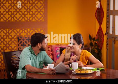 Gujrati couple talking during breakfast Stock Photo