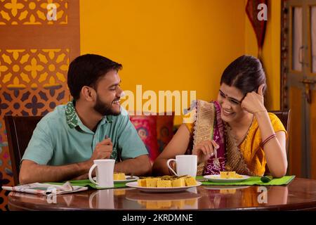 Gujrati couple talking during breakfast Stock Photo