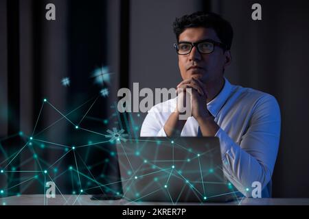 Businessman working on laptop computer with icons on virtual screen Stock Photo