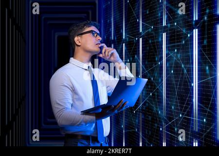 Technician working on the server in the data storage room. Stock Photo