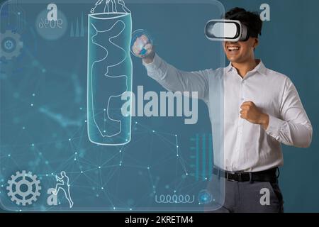 Man wearing VR headset and punching at digital Screen Stock Photo