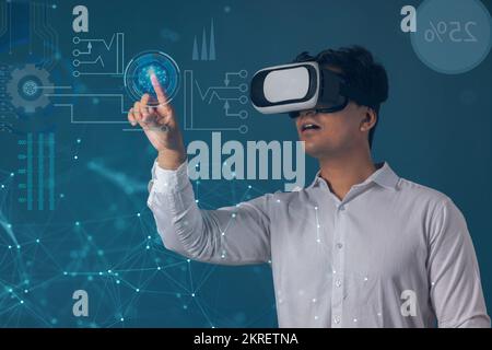 Man wearing VR headset and pointing at digital Screen Stock Photo
