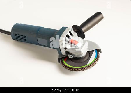 Modern professional angle grinder with a flap wheel on a white background. Power tool for work. Sanding wood and metal. Close-up Stock Photo