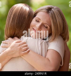 They share a special bond. A mother and daughter embracing each other. Stock Photo