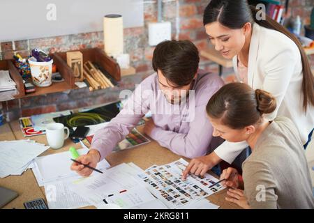 Working on their next campaigne. Young creative professionals working in an office. Stock Photo