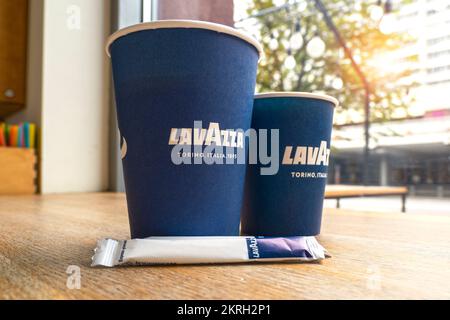MINSK - JULY 10: Close-up of two paper cups on a table with Lavazza coffee brand logotype in the Minsk Lavazza cafe on July 10. 2022 in Belarus Stock Photo