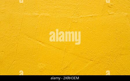 Rough blank wall painted by bright yellow paint as texture background or backdrop Stock Photo