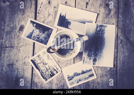 A moment in tracing back roots with a composition of tea décor and vintage photos Stock Photo