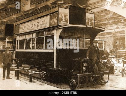 A 1930's British London open topped double-decker omnibus in the depot for repair and refurbishment.. Stock Photo