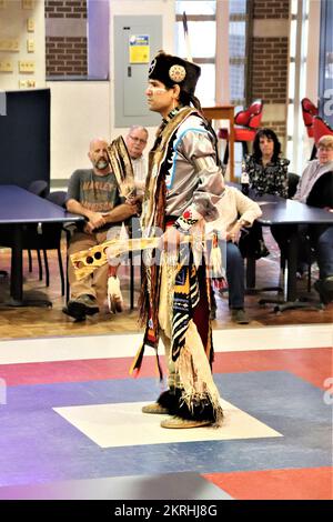 A member of the Wisconsin Dells Singers of the Ho-Chunk Nation of Wisconsin performs during the 2022 Fort McCoy Native American Heritage Month Observance in McCoy's Community Center at Fort McCoy, Wis. The Singers performed traditional Native music and dances in their regalia for dozens of Fort McCoy community members. November is Native American Heritage Month, or as it is commonly referred to, American Indian and Alaska Native Heritage Month. The month is a time to celebrate rich and diverse cultures, traditions, and histories and to acknowledge the important contributions of Native people. Stock Photo
