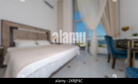 Defocused and blurred photo of luxury and modern bedroom with sea view in hotel apartment interior design. Ideal for background. Stock Photo