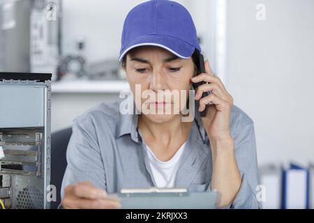 a woman fixing a pc Stock Photo