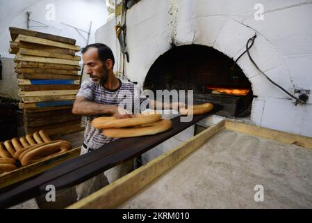 A traditional fire oven bakery specializing in Ka’ek Al-Quds - Sesame bagel bread. Christian quarter, Old city of Jerusalem. Stock Photo