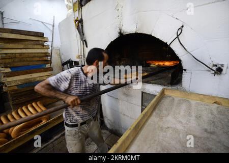 A traditional fire oven bakery specializing in Ka’ek Al-Quds - Sesame bagel bread. Christian quarter, Old city of Jerusalem. Stock Photo