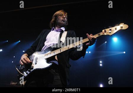 THE KILLERS, YOUNG, HOT FUSS TOUR, 2005: Mark Stoermer, bass player of The Killers, on the NME Tour at Cardiff University, February 6 2005. Photograph: ROB WATKINS.  The Killers are an American rock band formed in Las Vegas in 2001. Known for their energetic sound and hits like 'Mr. Brightside,' they gained fame with their debut album 'Hot Fuss' and have remained influential in indie and alternative rock. Stock Photo