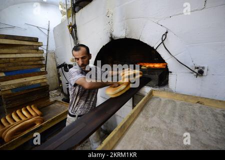 A traditional fire oven bakery specializing in Ka’ek Al-Quds - Sesame bagel bread. Christian quarter, Old city of Jerusalem. Stock Photo