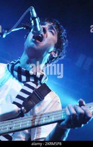 THE RAPTURE, YOUNG, CONCERT, 2004: Bassist MATT SAFER from the RAPTURE on the NME Tour at Cardiff Students' Union, Wales, UK on February 8 2004. Photograph: ROB WATKINS. INFO: The Rapture is an American dance-punk band formed in 1998. Known for their infectious blend of punk, rock, and dance music, they gained acclaim with their album 'Echoes' and hits like 'House of Jealous Lovers,' influencing the early 2000s indie scene. Stock Photo