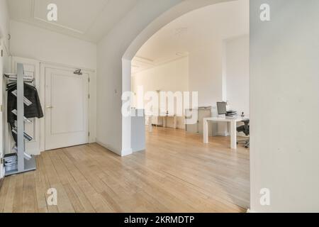 Interior of contemporary loft style office with comfortable chairs placed at tables with modern computers in daylight Stock Photo