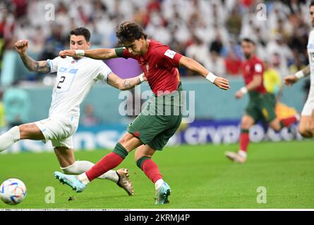 Joao Felix (11) of Portugal and Jose Maria Gimenez (2) of Uruguay during the FIFA World Cup Qatar 2022 Group H soccer match between Portugal 2-0 Uruguay at Lusail Iconic Stadium n November 26, 2022 in Lusail, Qatar. Credit: Takamoto Tokuhara/AFLO/Alamy Live News Stock Photo