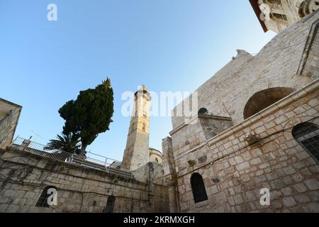 Looking up at the Omar mosque and the church of the holy Sepulchre in the Christian quarter in the old city of Jerusalem. Stock Photo