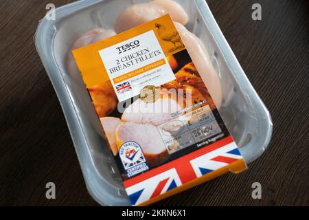 A packet of Tesco branded chicken on a kitchen worktop with a British flag marking on the packet and the Red Tractor Certified Standards label. UK Stock Photo