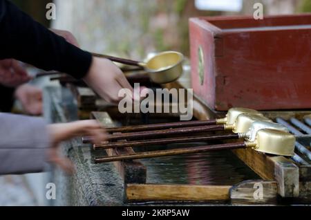 People performing ablutions, ceremonial purification rite known as ...