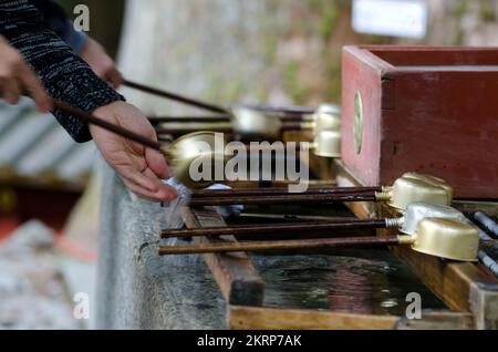 People performing ablutions, ceremonial purification rite known as ...
