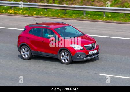 2014 Red Vauxhall MOKKA  EXCLUSIV S/S stop-start, 1598 cc petrol 5-speed SUV manual; travelling on the M6 motorway, UK Stock Photo