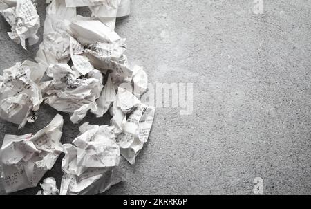 Many crumpled receipts from stores. The concept of shopping and purchases. Gray background. copy space. Stock Photo