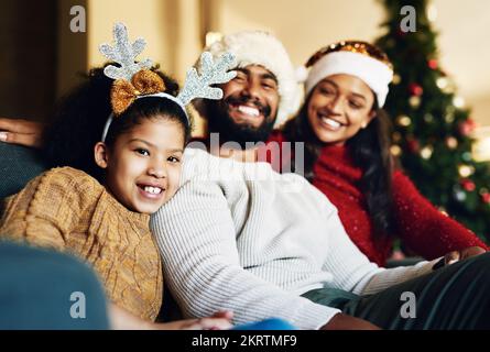 Happy family, christmas hat or bonding in house or home living room on celebration holiday, festive event or vacation. Portrait, smile or xmas girl Stock Photo