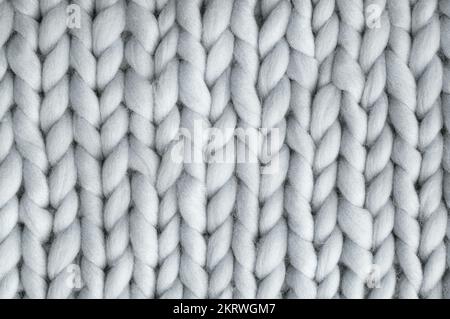 Close up above view of grey soft wool knitted wool background. Stock Photo