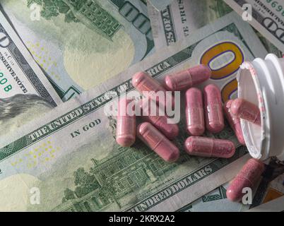red pills on background of cash money, drug industry concept Stock Photo