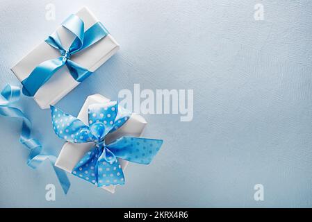 Holidays blue background with gift box. Top view with copy space Stock Photo