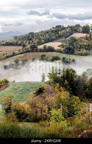 Morning mist and clouds over the Montefeltro hills near Belvedere Fogliense between Pesaro and Urbino in the Marche region of Italy Stock Photo
