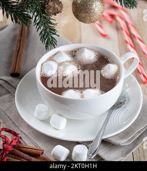 Cup of hot chocolate with marshmallows on a wooden table with Christmas decorations Stock Photo