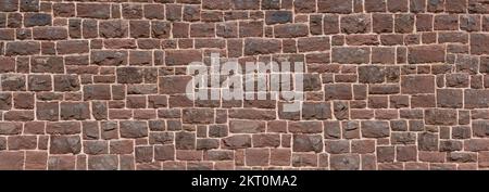 Old panoramic wall made of red sandstone - closeup of a church wall Stock Photo