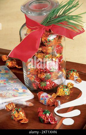 Sweets in a large glass jar on table Stock Photo