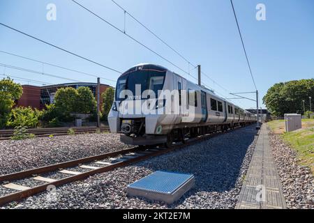 Railway worker inspecting sidings on new railway track with trains in Stevenage Stock Photo