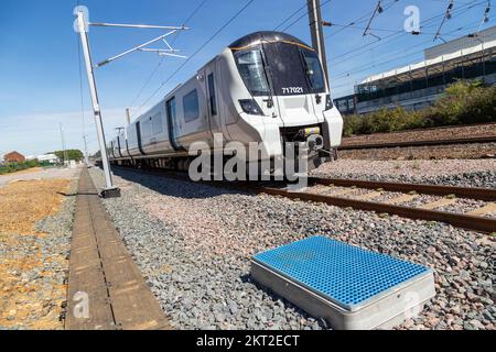 Railway worker inspecting sidings on new railway track with trains Stock Photo