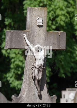 photo of a white broken statue of Jesus Christ on a concrete cross Stock Photo