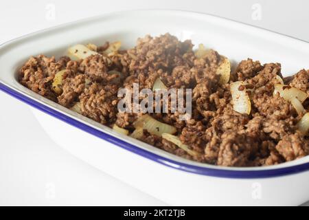Minced beef with onion in a traditional enamel dish. Stock Photo
