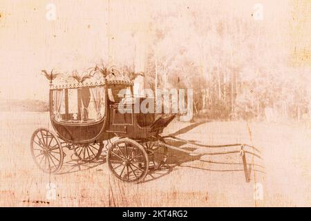 Vintage faded and tatted horizontal photo of old funeral hearse parked in a sepia toned park. Nostalgia in passing Stock Photo