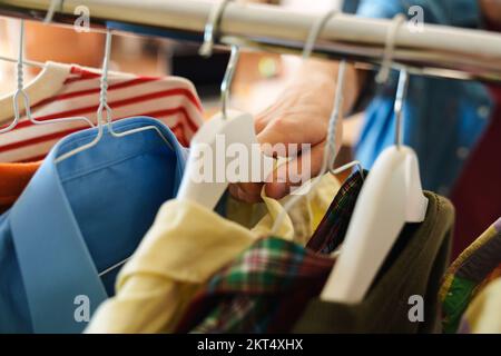 Close up male hand choosing clothes  Stock Photo