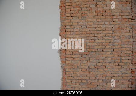 Plaster with exposed brick during the renovation Stock Photo